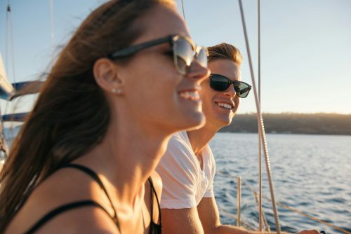 Couple enjoying view on sailboat, San Diego Bay, California, USA